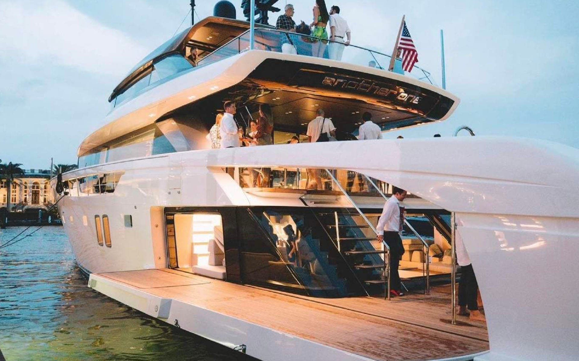Guests on the decks of the 112' Sanlorenzo at dusk