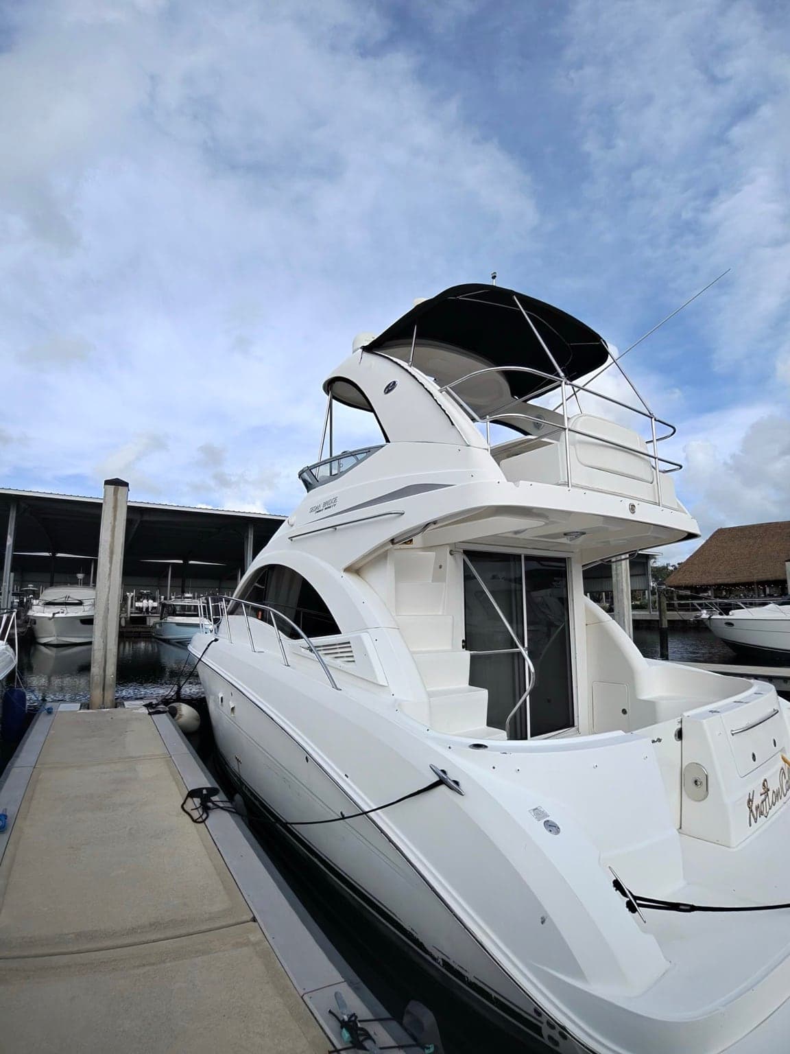 The 39' Sea Ray Flybridge at the dock, with her shaded flybridge and aft cockpit