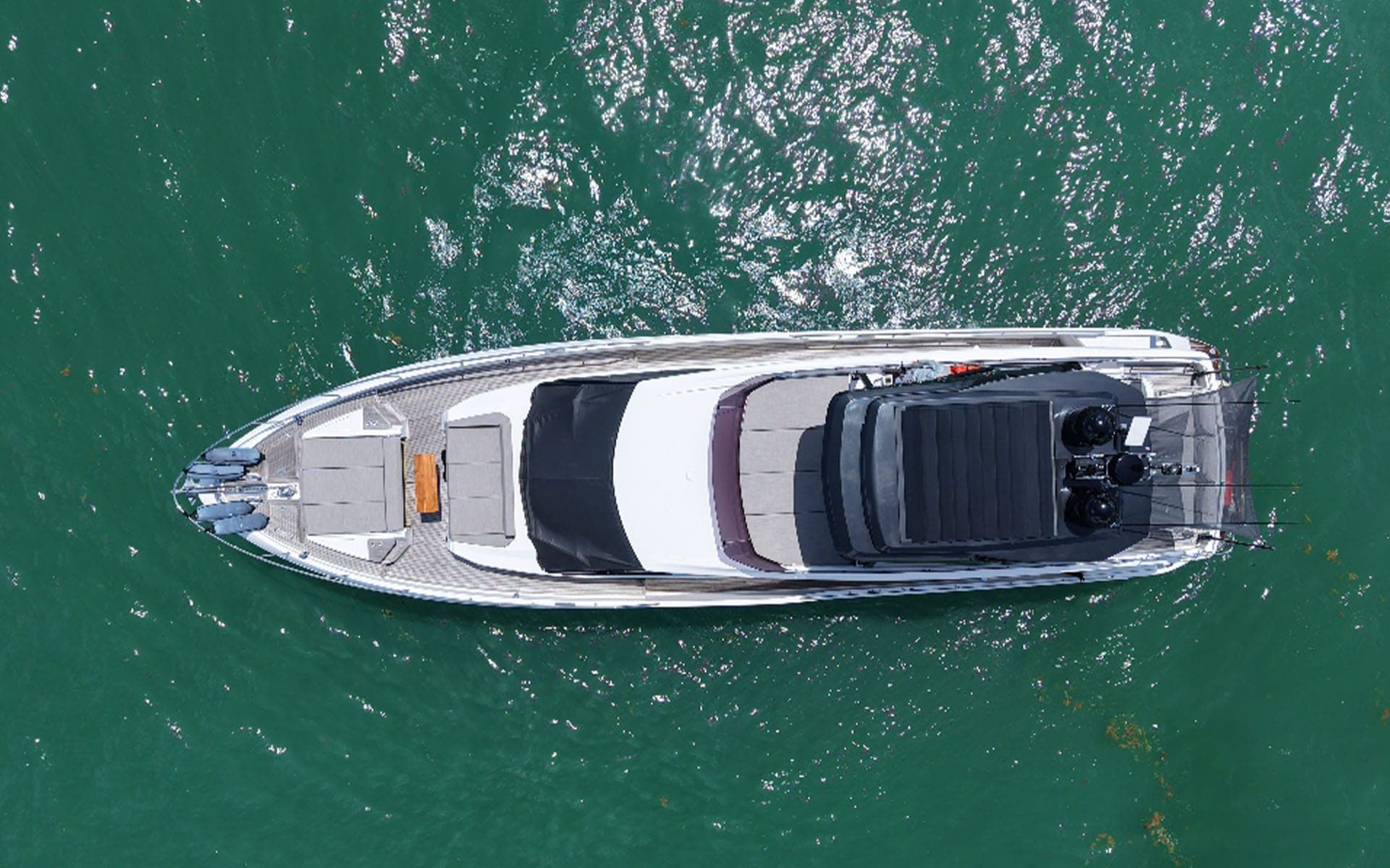 The 80' Ferretti seen from directly above on green water