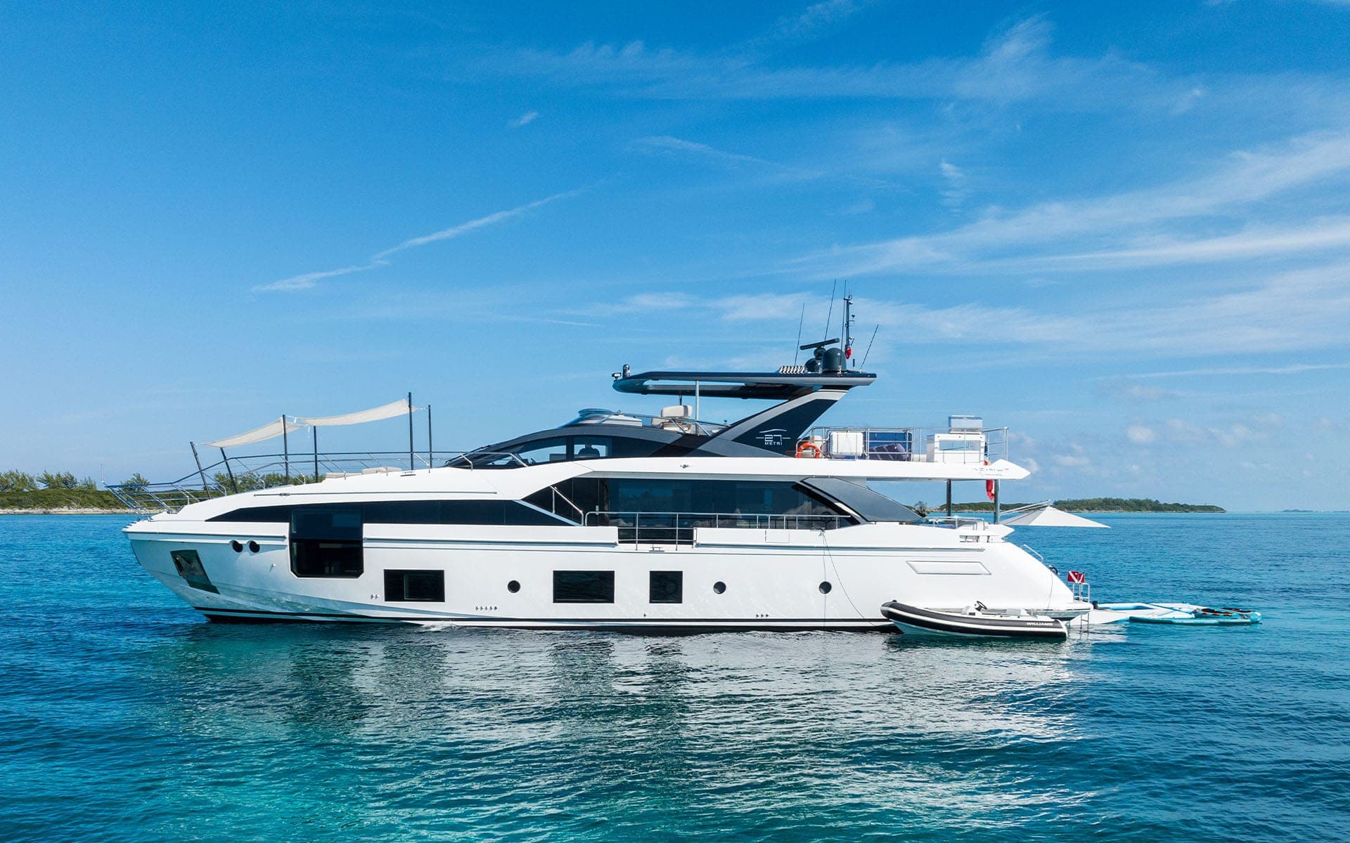 Profile of the 88' Azimut at anchor on turquoise water