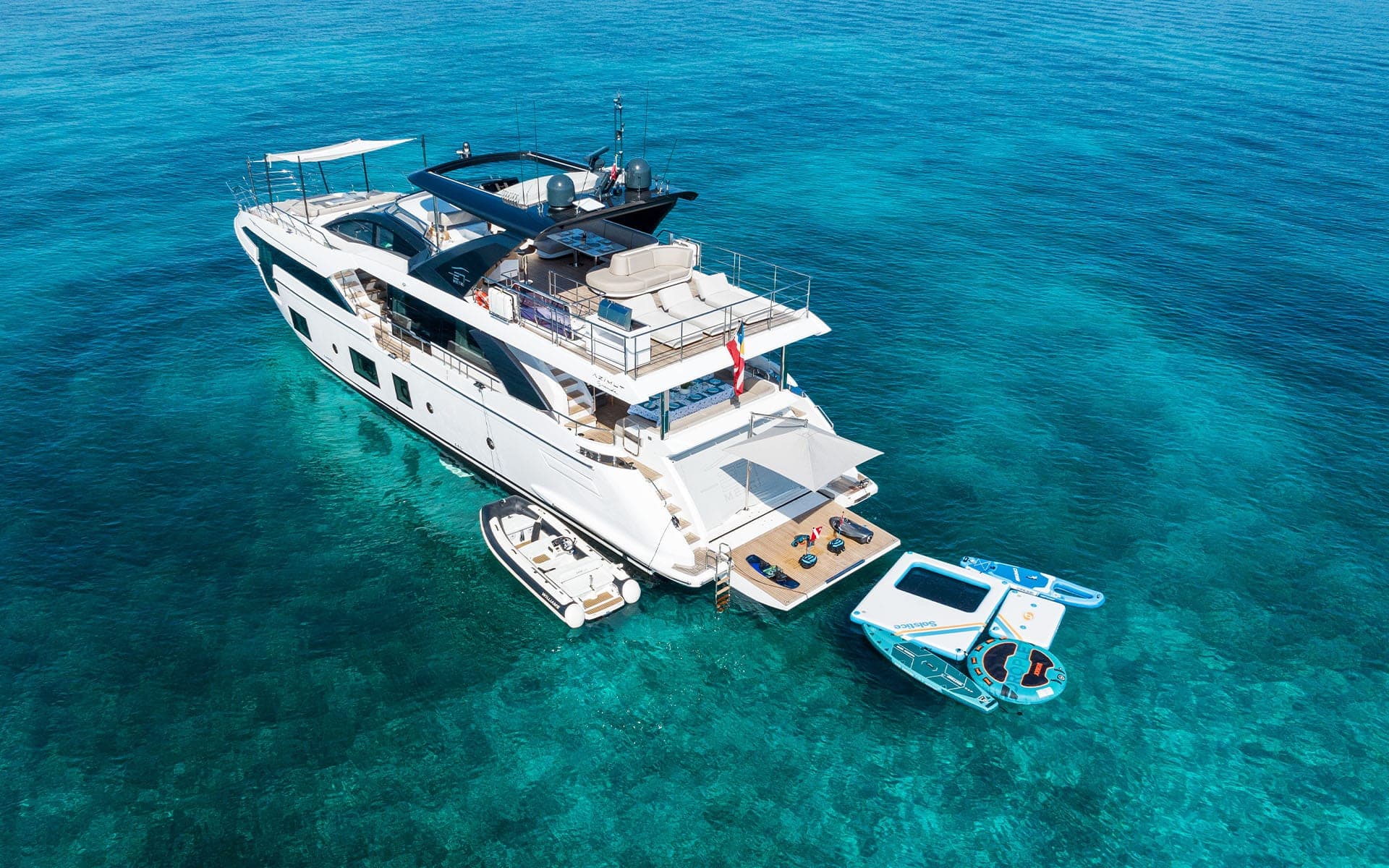 The 88' Azimut at anchor with her tender and water toys