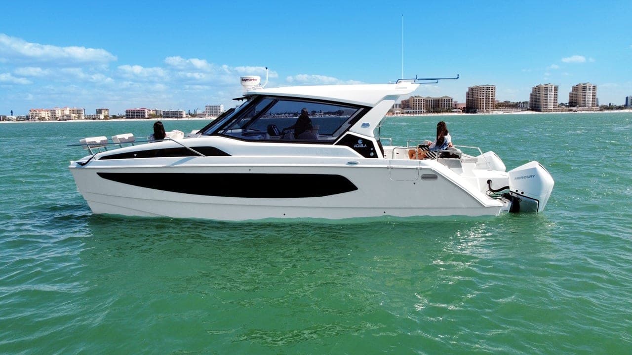 36' Aquila power catamaran cruising off the beach, Well Played Editions charter yacht on Tampa Bay
