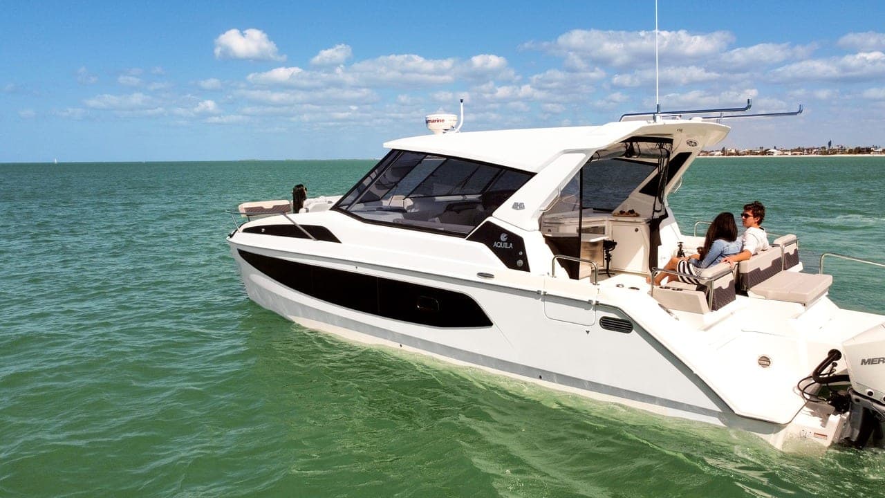 Guests relaxing in the cockpit of the 36' Aquila under way